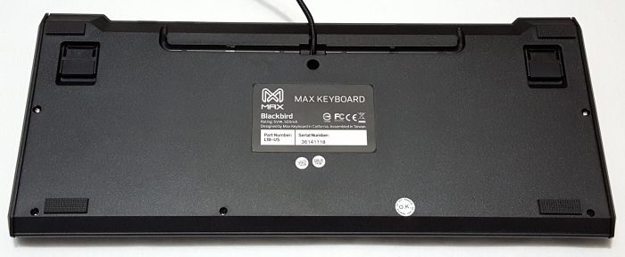 Bottom view showing rubber feet for traction, cable routing gutter and product information sticker