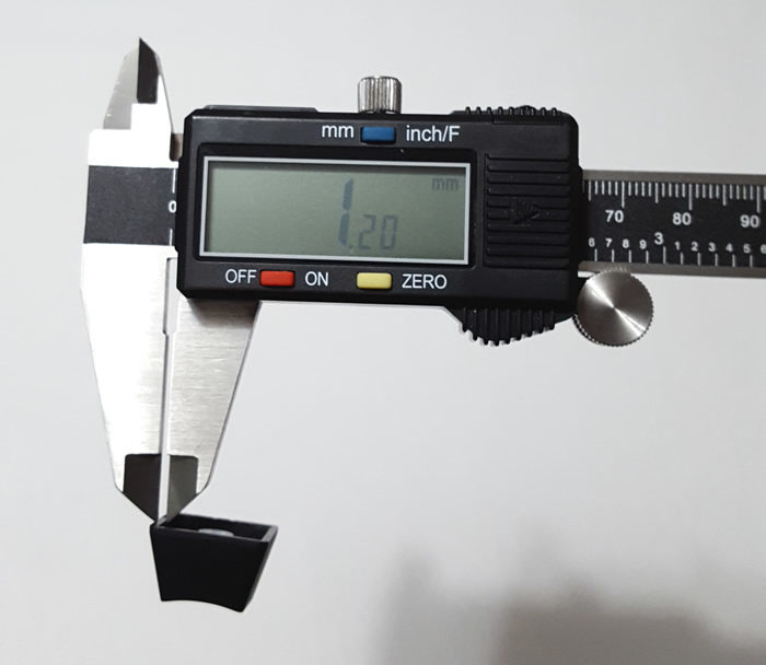 Keycap measuring 1.2mm thick on a caliper